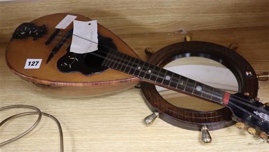 A 19th century mandolin with label Giovani Demeglio and an oak porthole wall mirror from SS Himalaya